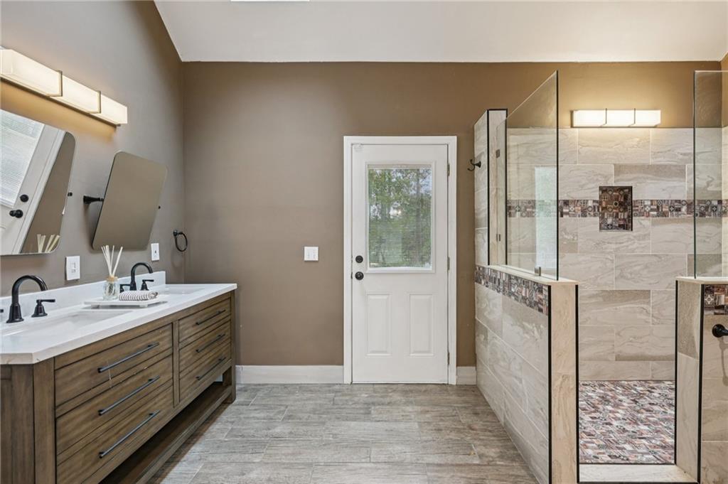 7379 North Mitchell Court Villa Rica, GA 30180 - Photo 33 of 82 a bathroom with a double vanity sink a mirror and shower