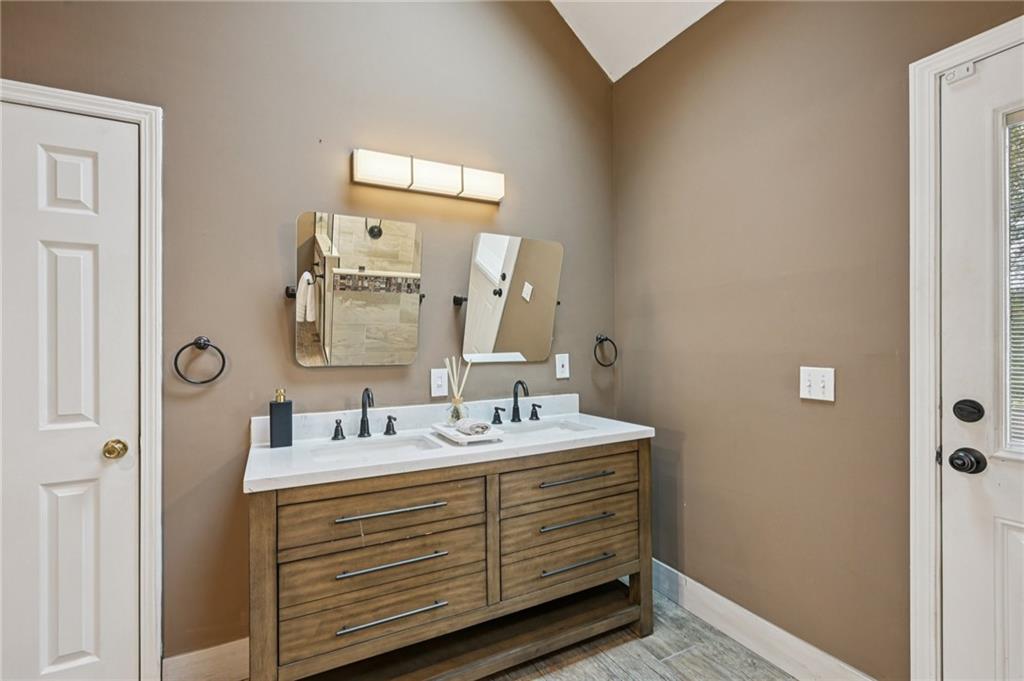 7379 North Mitchell Court Villa Rica, GA 30180 - Photo 36 of 82 a bathroom with a double vanity sink and mirror