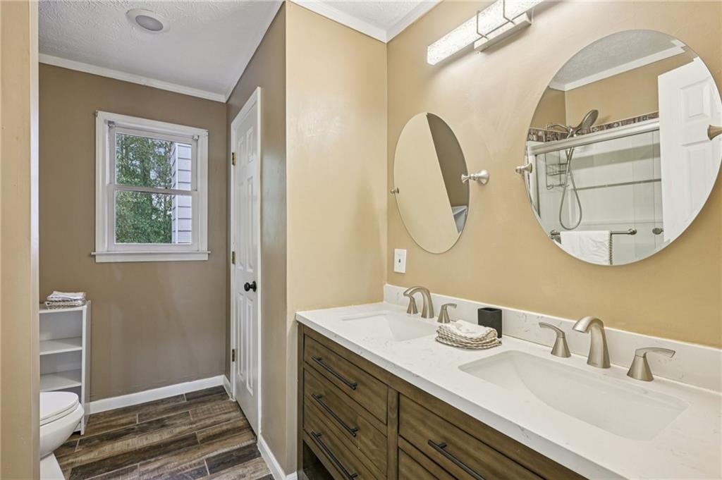 7379 North Mitchell Court Villa Rica, GA 30180 - Photo 40 of 82 a bathroom with a double vanity sink and a mirror