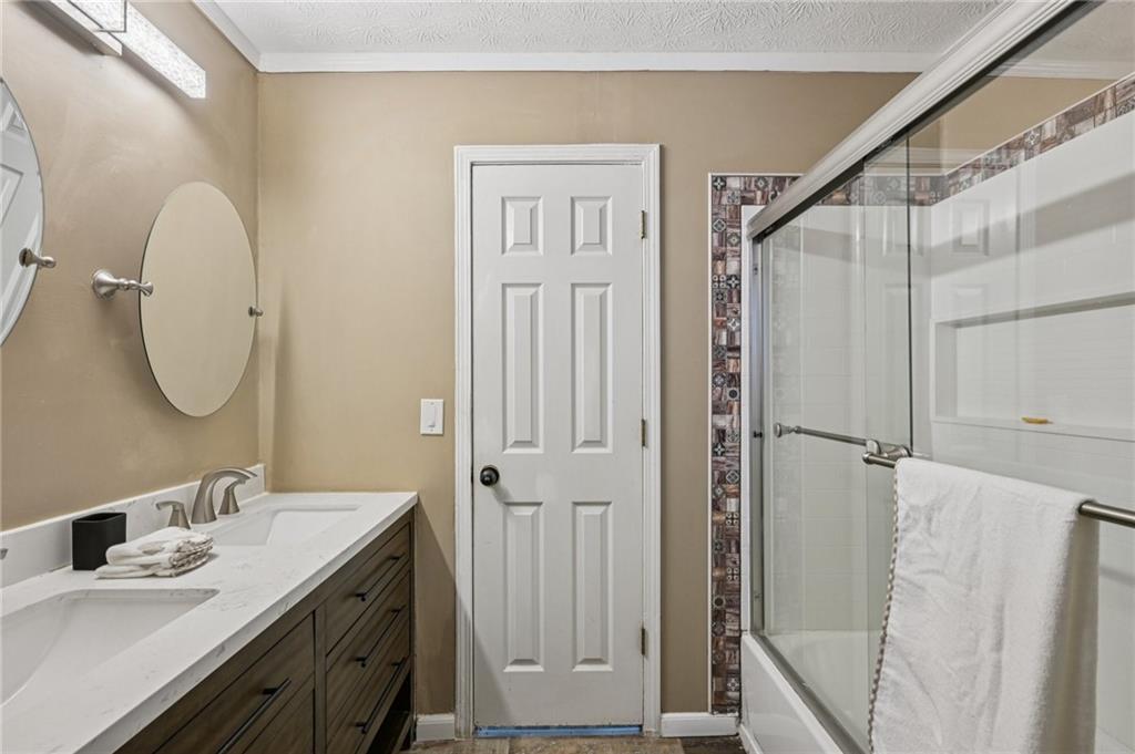 7379 North Mitchell Court Villa Rica, GA 30180 - Photo 41 of 82 a bathroom with a sink a mirror a vanity and a shower
