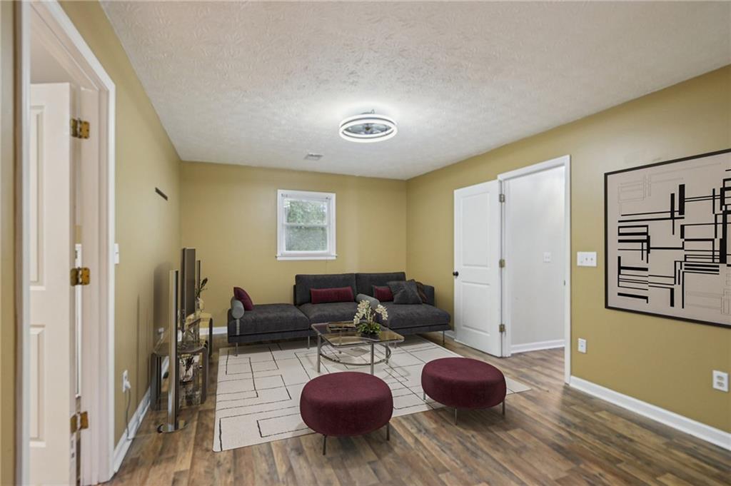 7379 North Mitchell Court Villa Rica, GA 30180 - Photo 45 of 82 a living room with furniture and a wooden floor