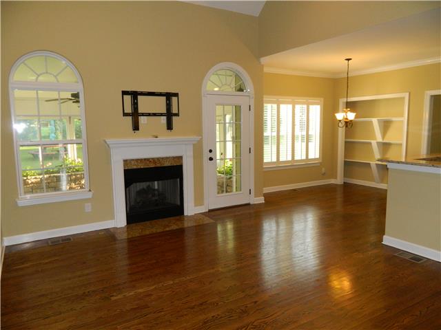 230 Curd Road Mount Juliet, TN 37122 - Photo 3 of 13 a view of a livingroom with wooden floor a fireplace and windows