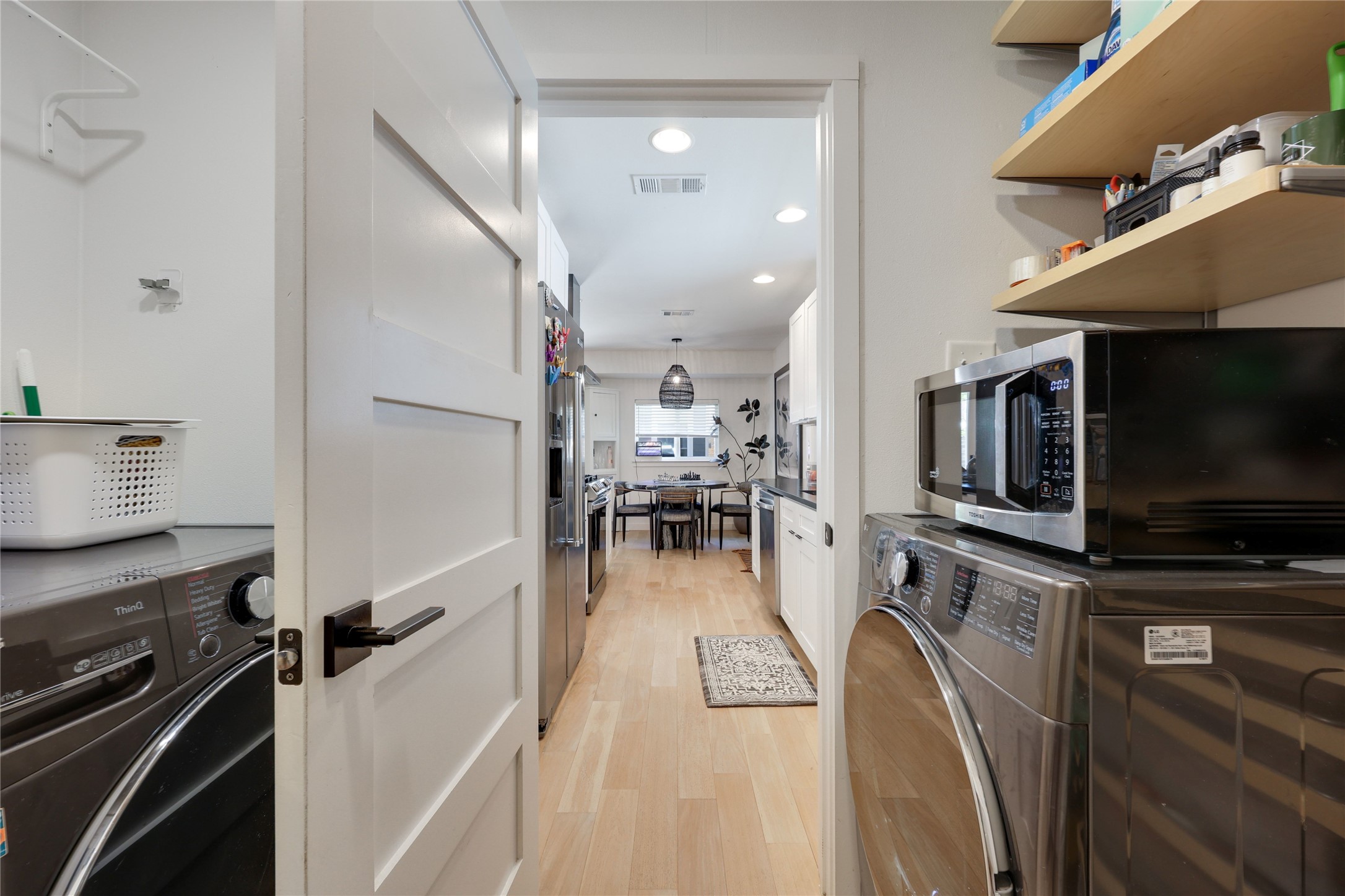 7902 Copano Drive Austin, TX 78749 - Photo 11 of 25 a view of a kitchen with kitchen island wooden floor and electronic appliances