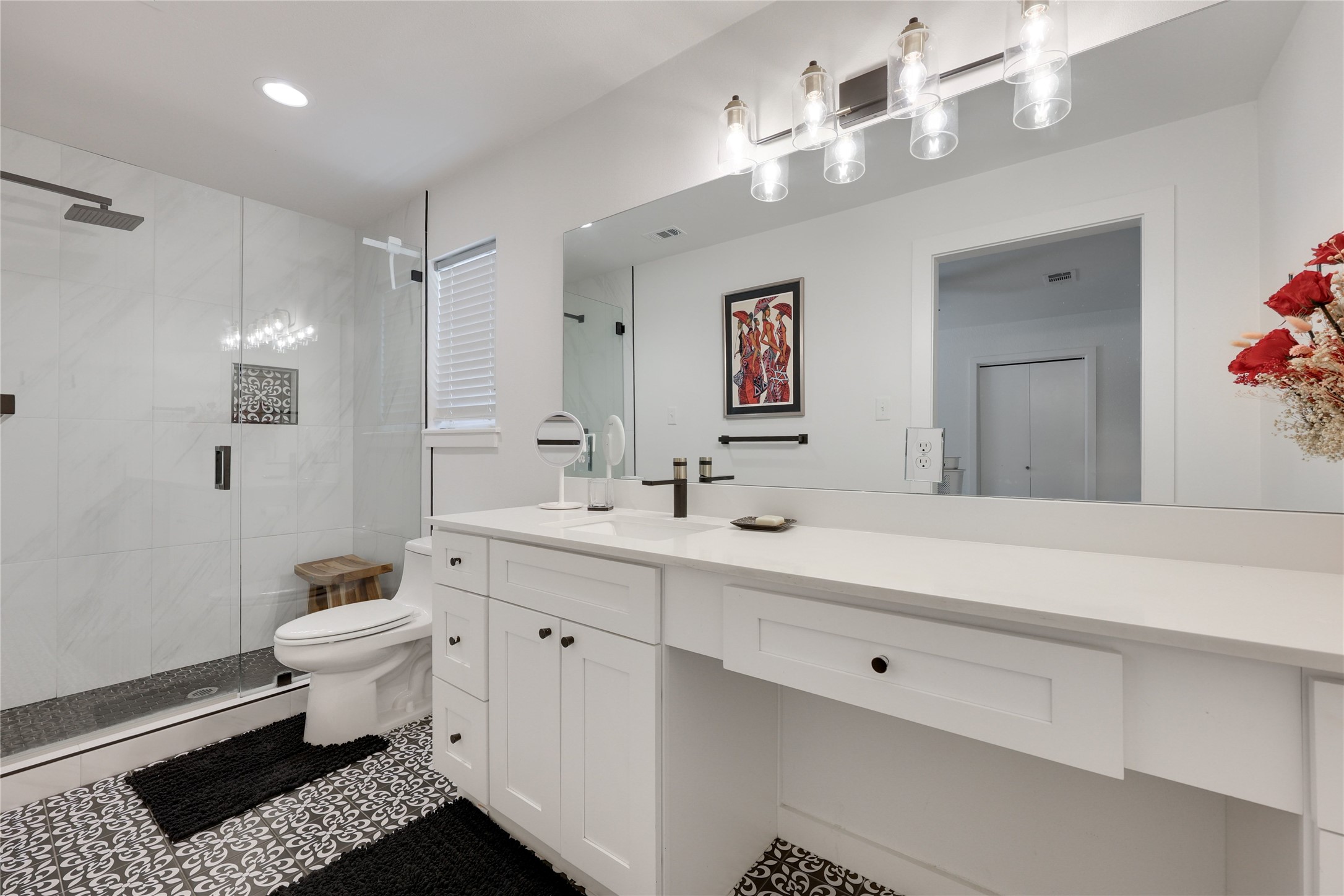 7902 Copano Drive Austin, TX 78749 - Photo 15 of 25 a bathroom with a sink a toilet a mirror and shower