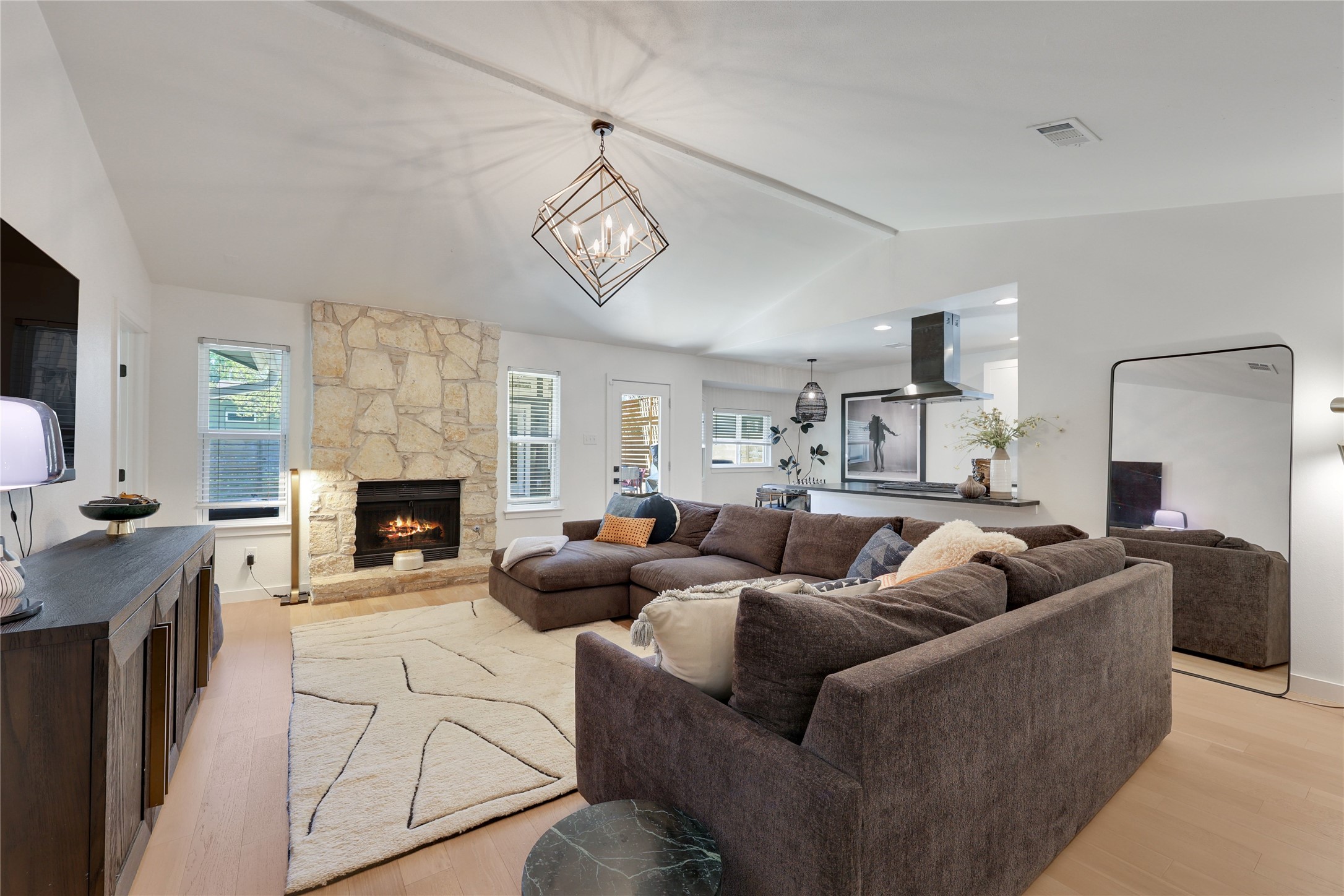 7902 Copano Drive Austin, TX 78749 - Photo 6 of 25 a living room with furniture a fireplace and a flat screen tv