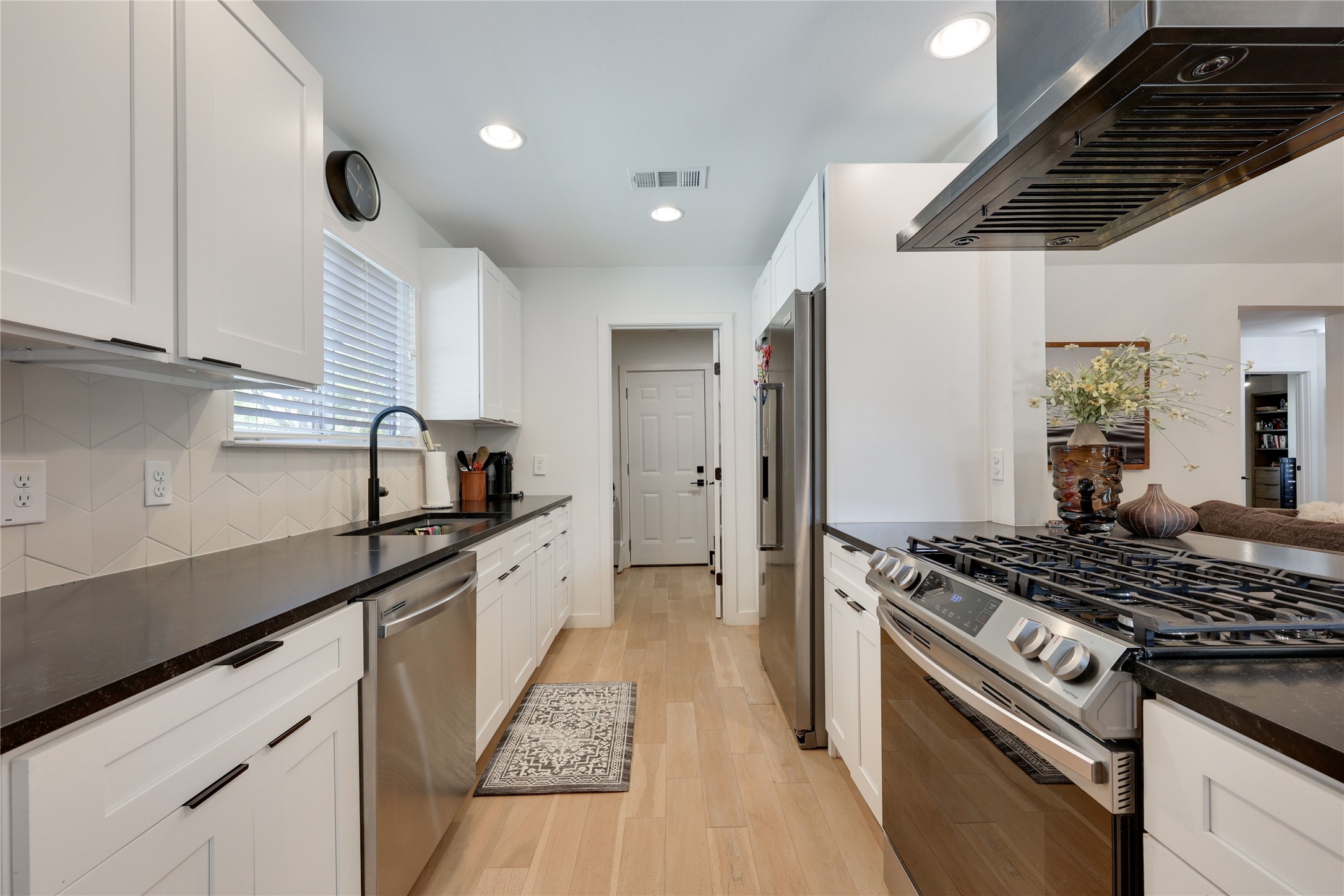 7902 Copano Drive Austin, TX 78749 - Photo 9 of 25 a kitchen with stainless steel appliances granite countertop a sink a stove and a refrigerator