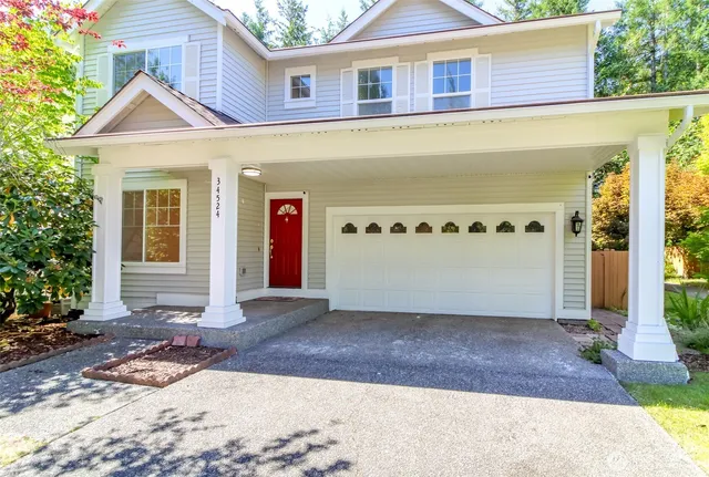 a front view of a house with a yard and garage