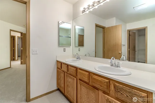 a bathroom with 2 sink and a mirror