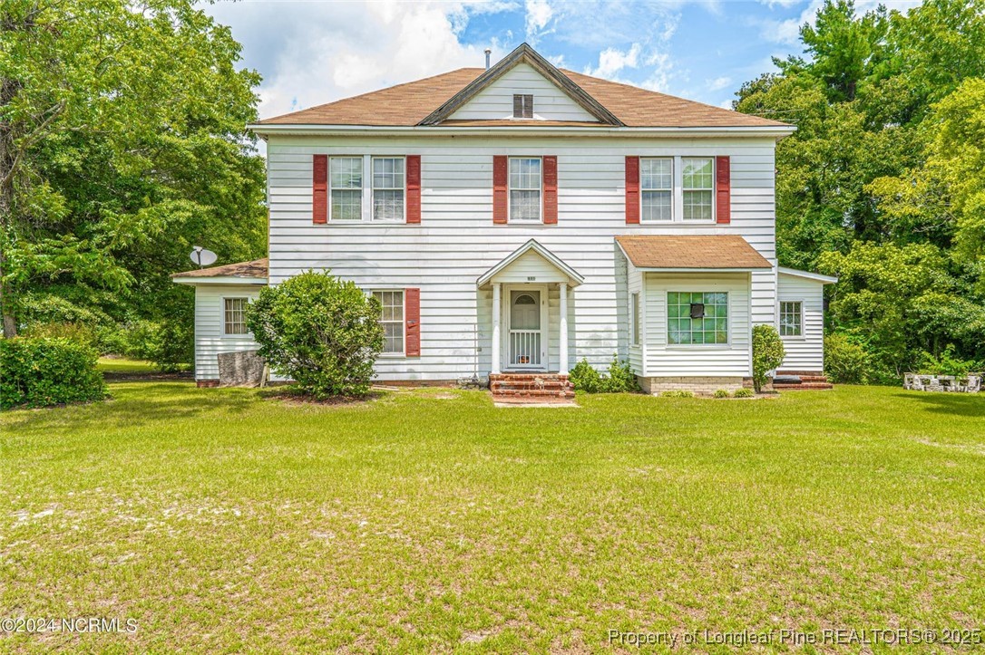 801 Monroe Street Carthage, NC 28327 - Photo 1 of 20 a front view of a house with a garden