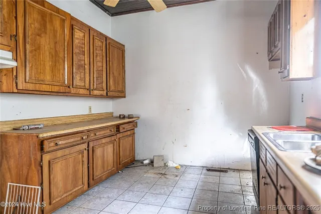 a kitchen with granite countertop a sink and cabinets