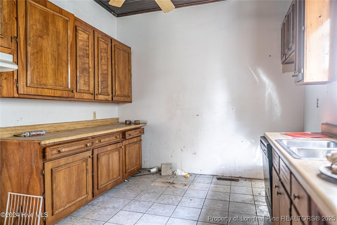 801 Monroe Street Carthage, NC 28327 - Photo 12 of 20 a kitchen with granite countertop a sink and cabinets