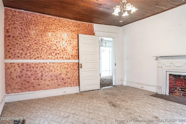 a view of an empty room with a fireplace