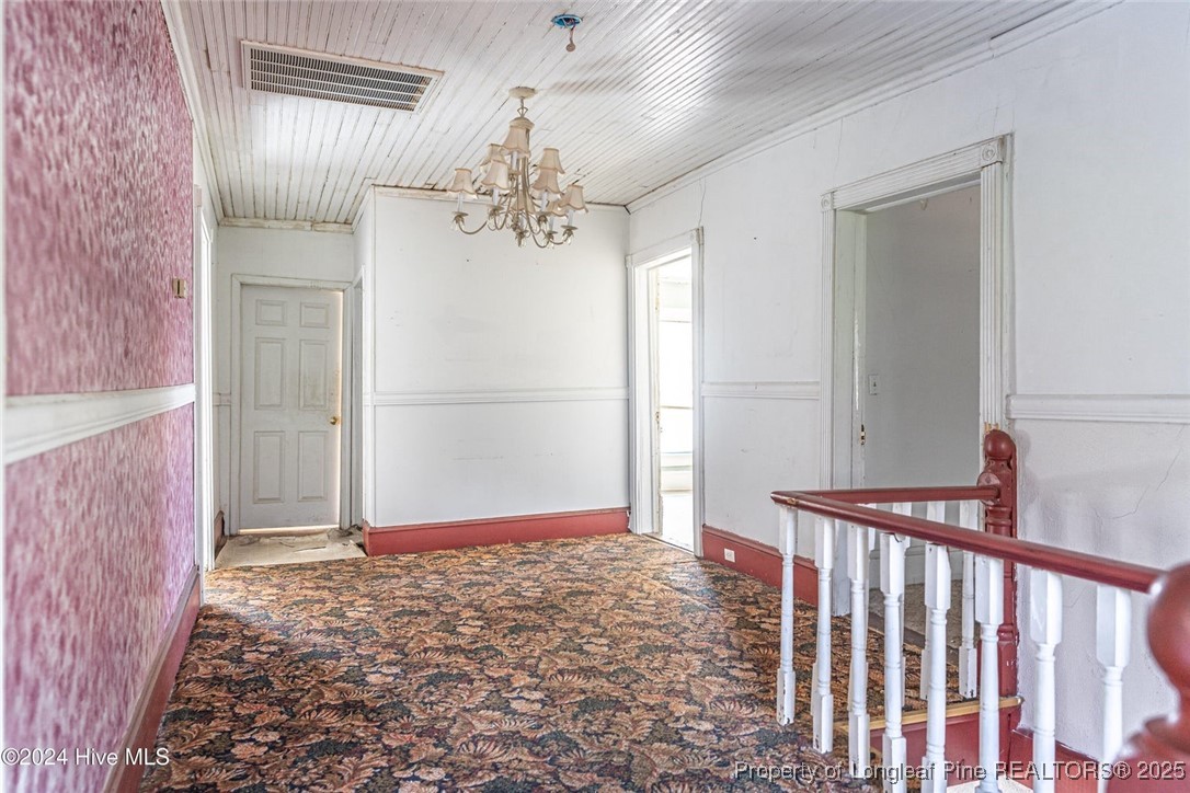801 Monroe Street Carthage, NC 28327 - Photo 15 of 20 a view of a hallway with a chandelier