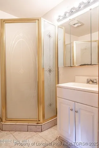 a bathroom with a shower and a sink