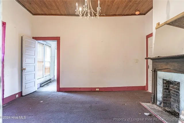 a view of empty room with fireplace