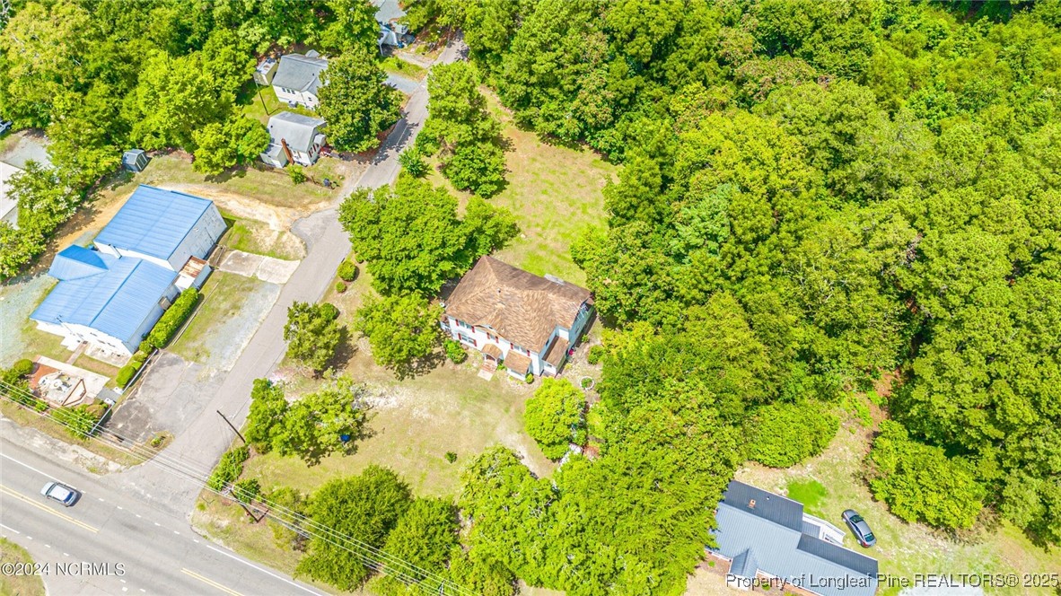 801 Monroe Street Carthage, NC 28327 - Photo 3 of 20 an aerial view of residential house with outdoor space and trees all around