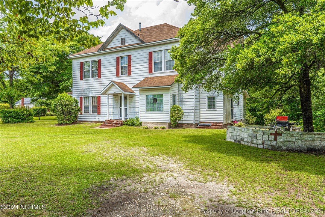 801 Monroe Street Carthage, NC 28327 - Photo 5 of 20 a front view of a house with garden