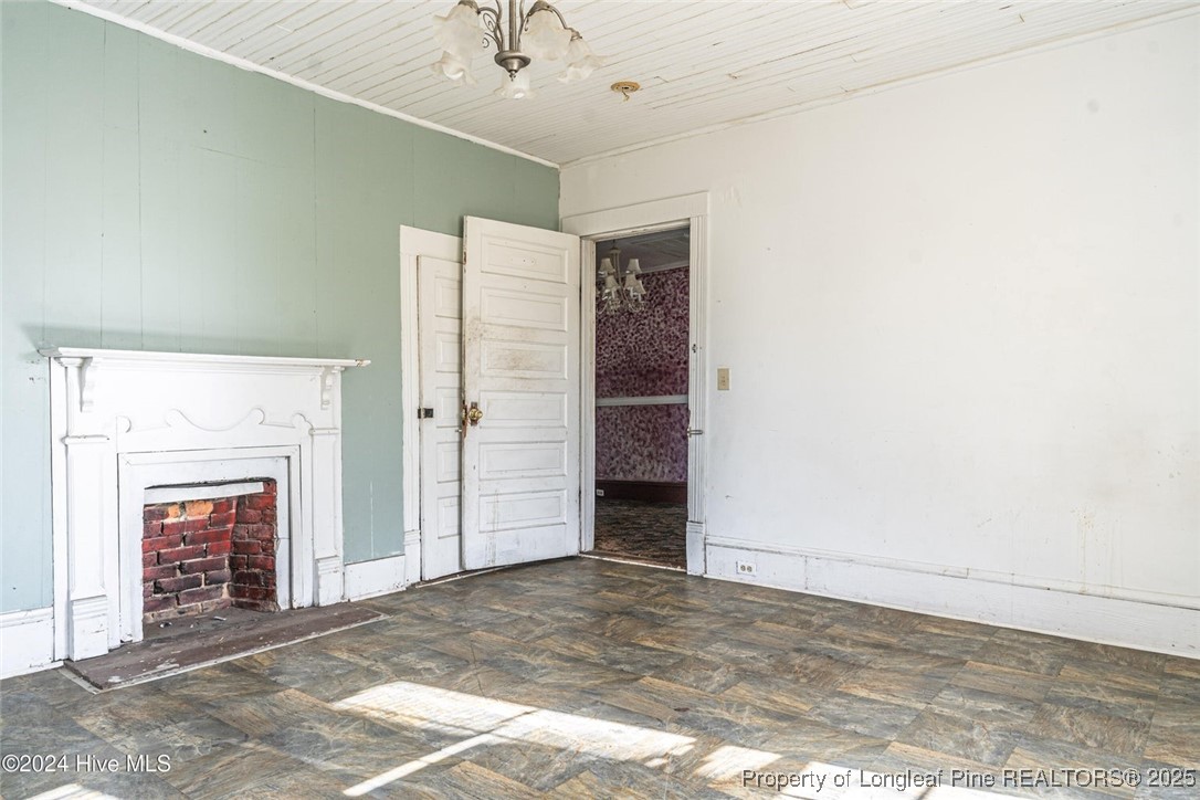 801 Monroe Street Carthage, NC 28327 - Photo 10 of 20 an empty room with a fireplace