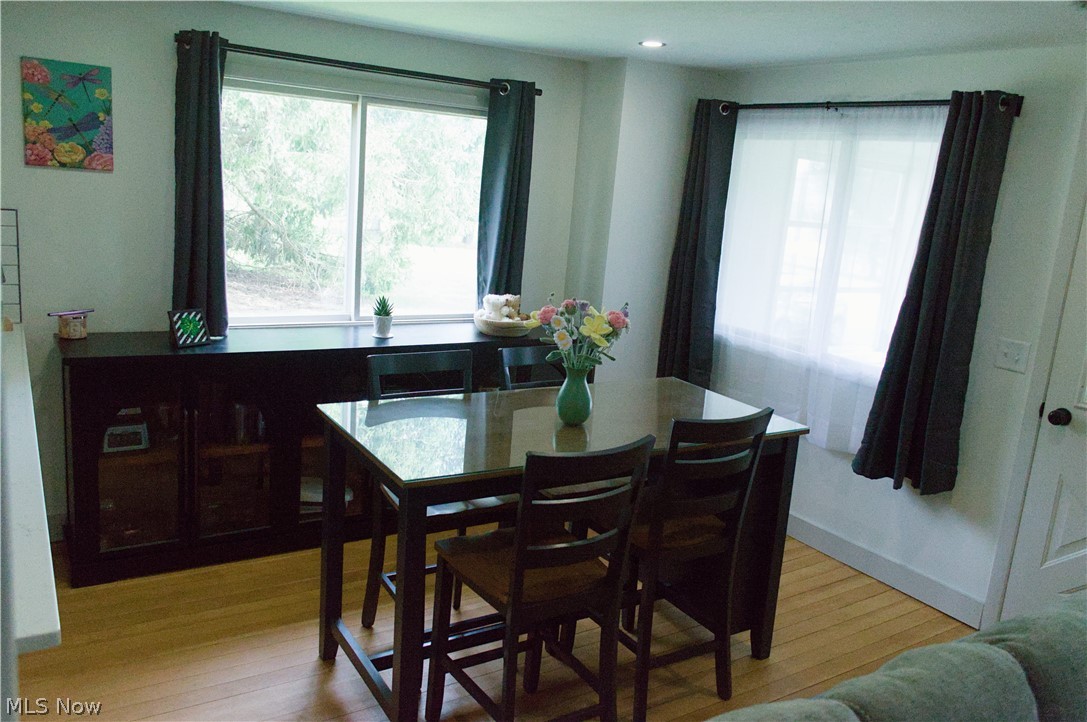 3187 Grenfall Road Barberton, OH 44203 - Photo 7 of 17 Dining space featuring hardwood floors and a window with dark curtains
