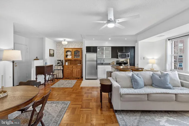 a living room with furniture and kitchen view