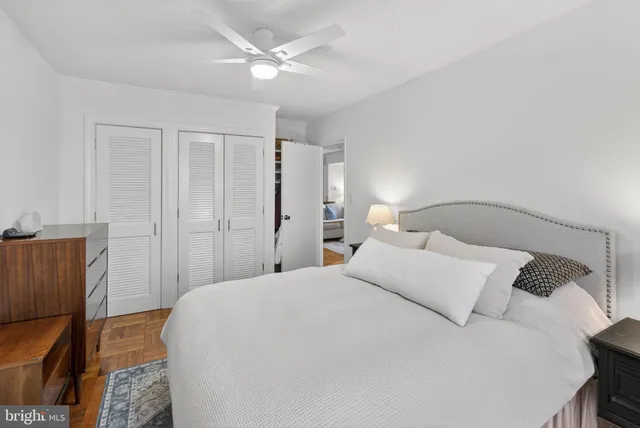 a bedroom with a large bed and a chandelier