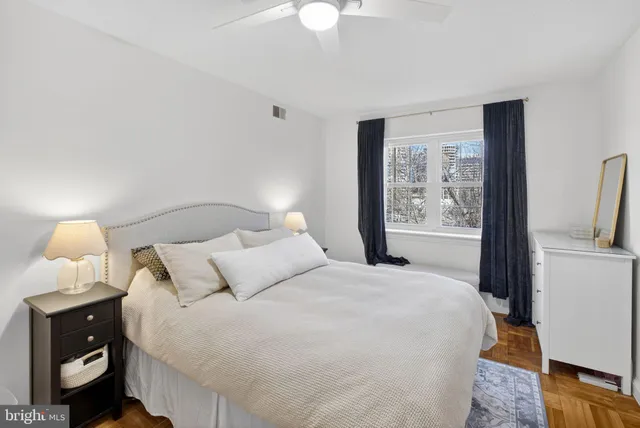 a bedroom with a bed and a lamp