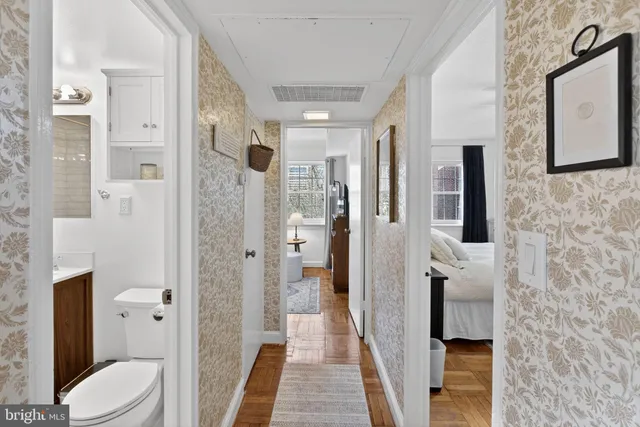 a bathroom with a granite countertop shower a toilet and a sink