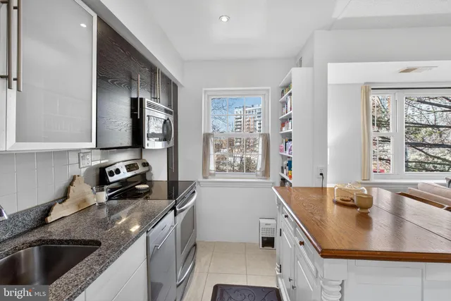 a kitchen that has a sink a stove and window