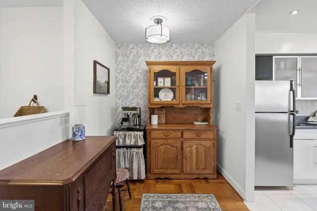 a kitchen with a refrigerator a sink and cabinets