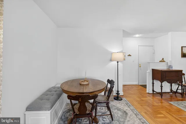 a view of a room with a table and chairs