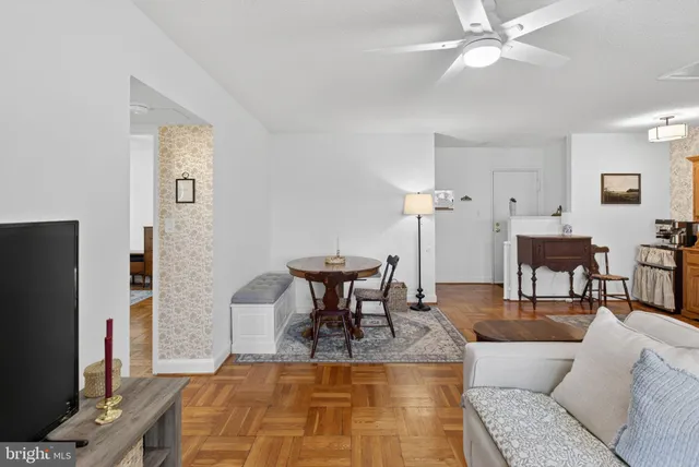 a living room with furniture a table and a flat screen tv