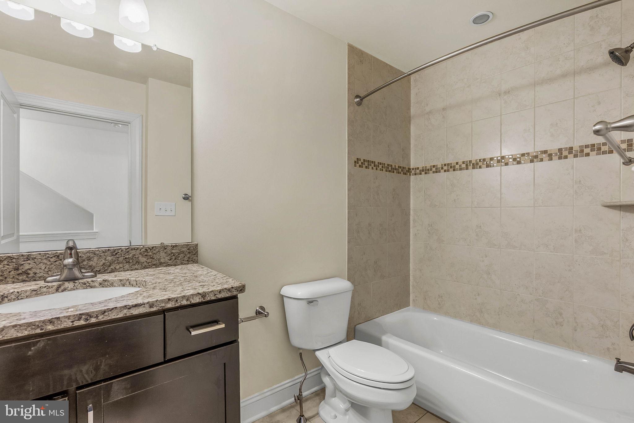 1015 North 3rd Street, Unit H Philadelphia, PA 19123 - Photo 19 of 27 a bathroom with a granite countertop sink toilet and shower