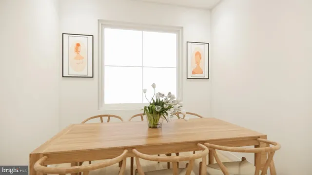 a view of a dining room with furniture and a potted plant