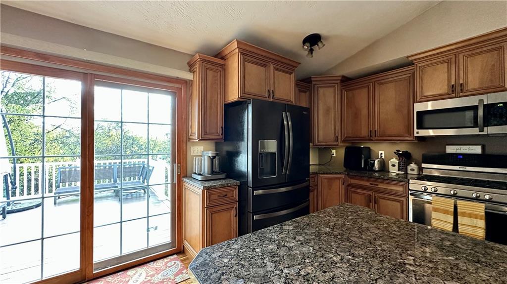 6949 Shannon Road Verona, PA 15147 - Photo 13 of 49 a kitchen with stainless steel appliances granite countertop a refrigerator stove and sink