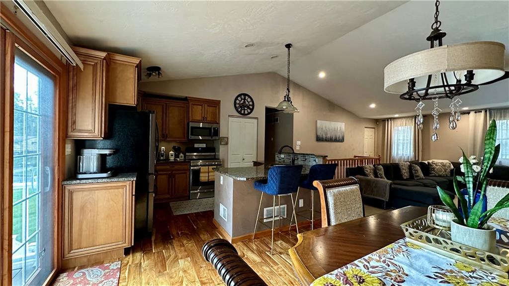 6949 Shannon Road Verona, PA 15147 - Photo 15 of 49 a living room with furniture kitchen view and a chandelier