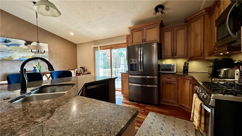 6949 Shannon Road Verona, PA 15147 - Photo 16 of 49 a kitchen with a refrigerator stove and a sink