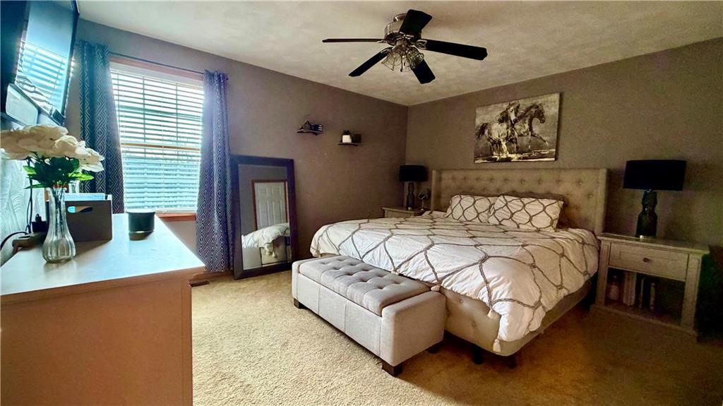 6949 Shannon Road Verona, PA 15147 - Photo 18 of 49 a bedroom with a large bed a potted plant on dresser and a window