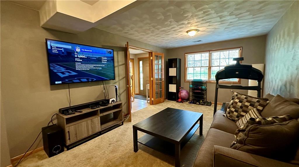 6949 Shannon Road Verona, PA 15147 - Photo 30 of 49 a living room with furniture a flat screen tv and a refrigerator