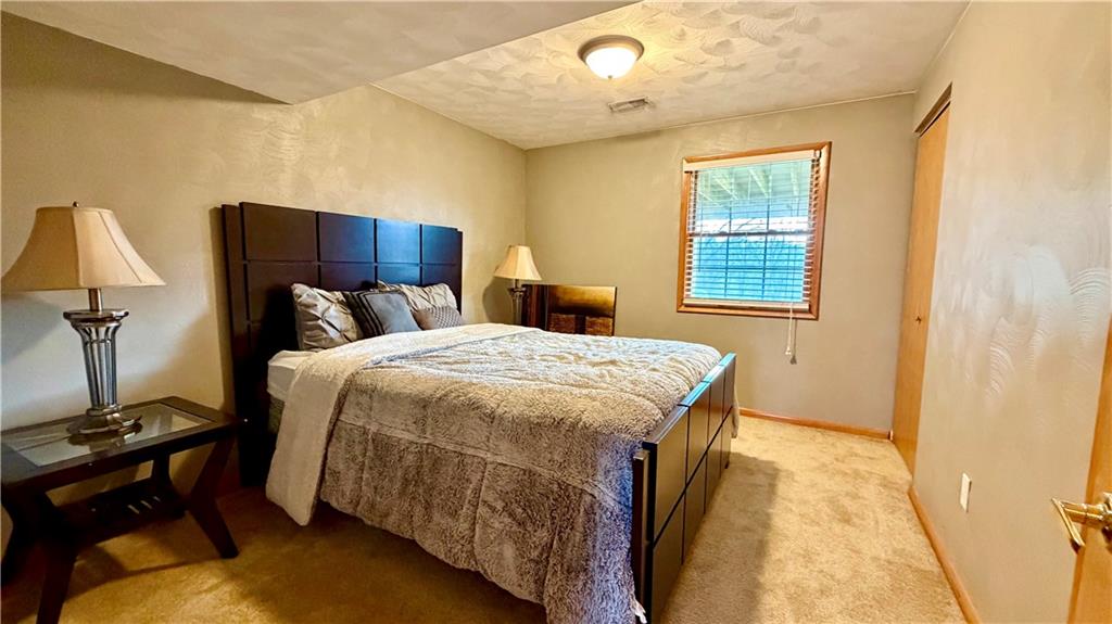 6949 Shannon Road Verona, PA 15147 - Photo 32 of 49 a bedroom with a bed and wooden floor