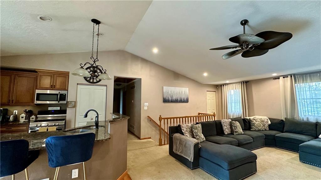 6949 Shannon Road Verona, PA 15147 - Photo 8 of 49 a living room with furniture a chandelier and a flat screen tv