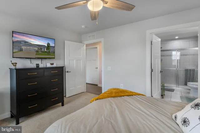 a bathroom with a sink a toilet and a large mirror