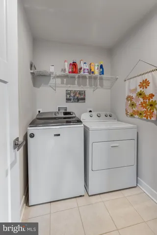 a living room with furniture a table and chairs