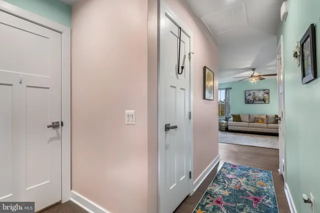 a living room with furniture kitchen view and a large window
