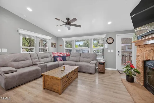 a living room with furniture a window and a flat screen tv