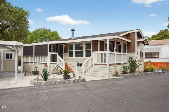 a view of a house with a patio and a yard