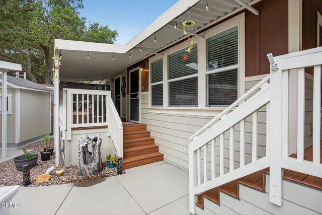 a view of house with wooden stairs and windows