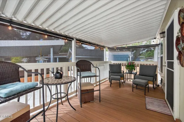a view of a patio with table and chairs and wooden floor