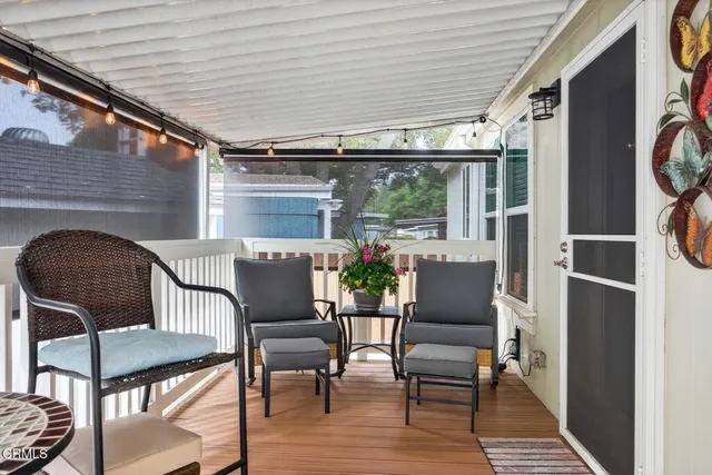 a view of a house with backyard and deck