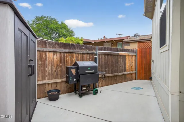 a dining room with wooden floor a chandelier a wooden table and chairs