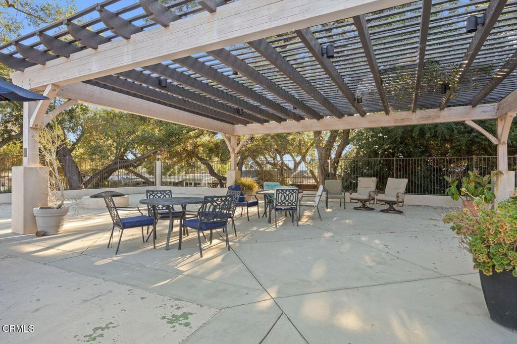 1273 South Rice Road, Unit 53 Ojai, CA 93023 - Photo 31 of 42 a view of a patio with a table and chairs under an umbrella